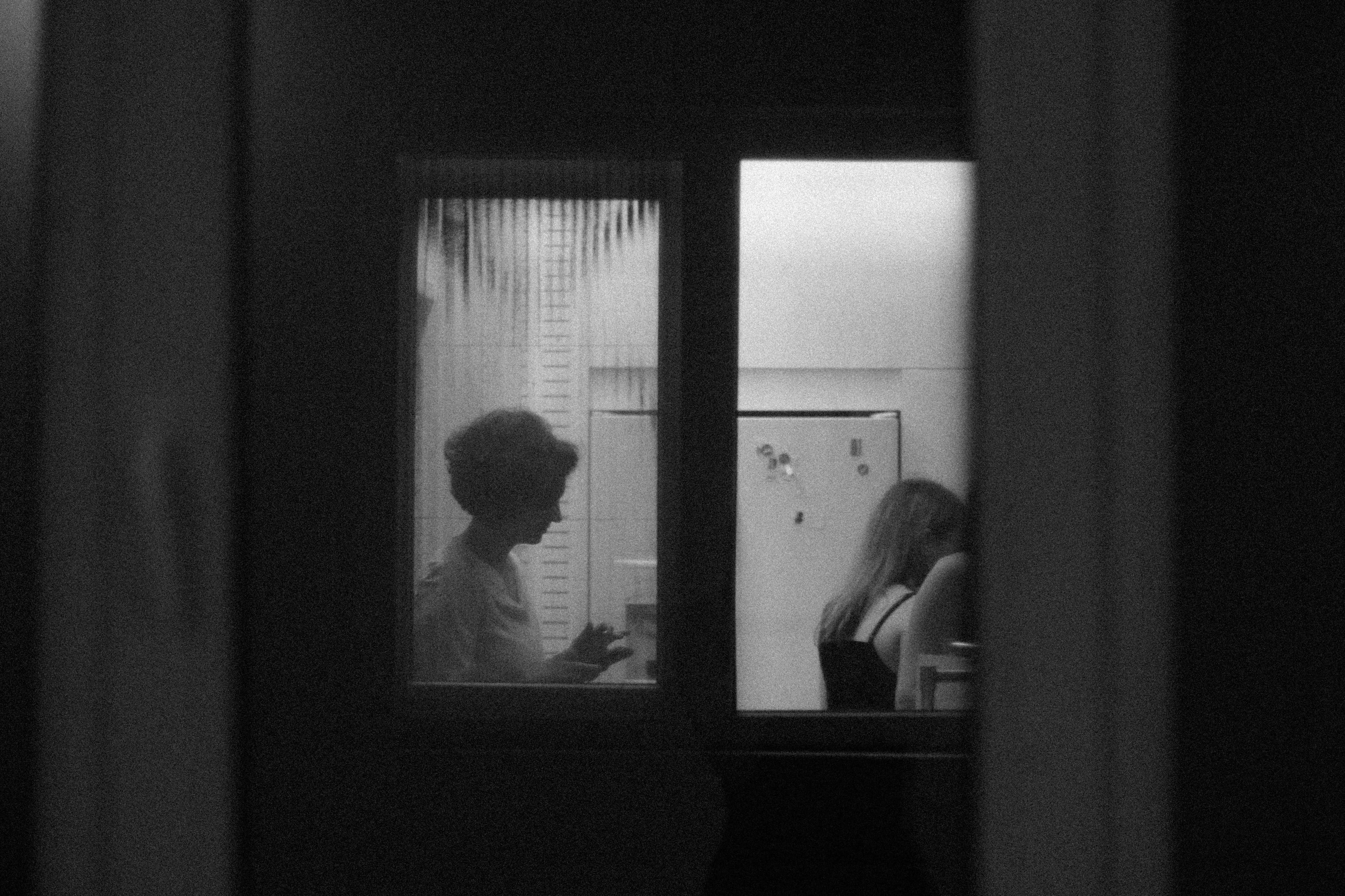 A woman standing in front of a refrigerator in a kitchen